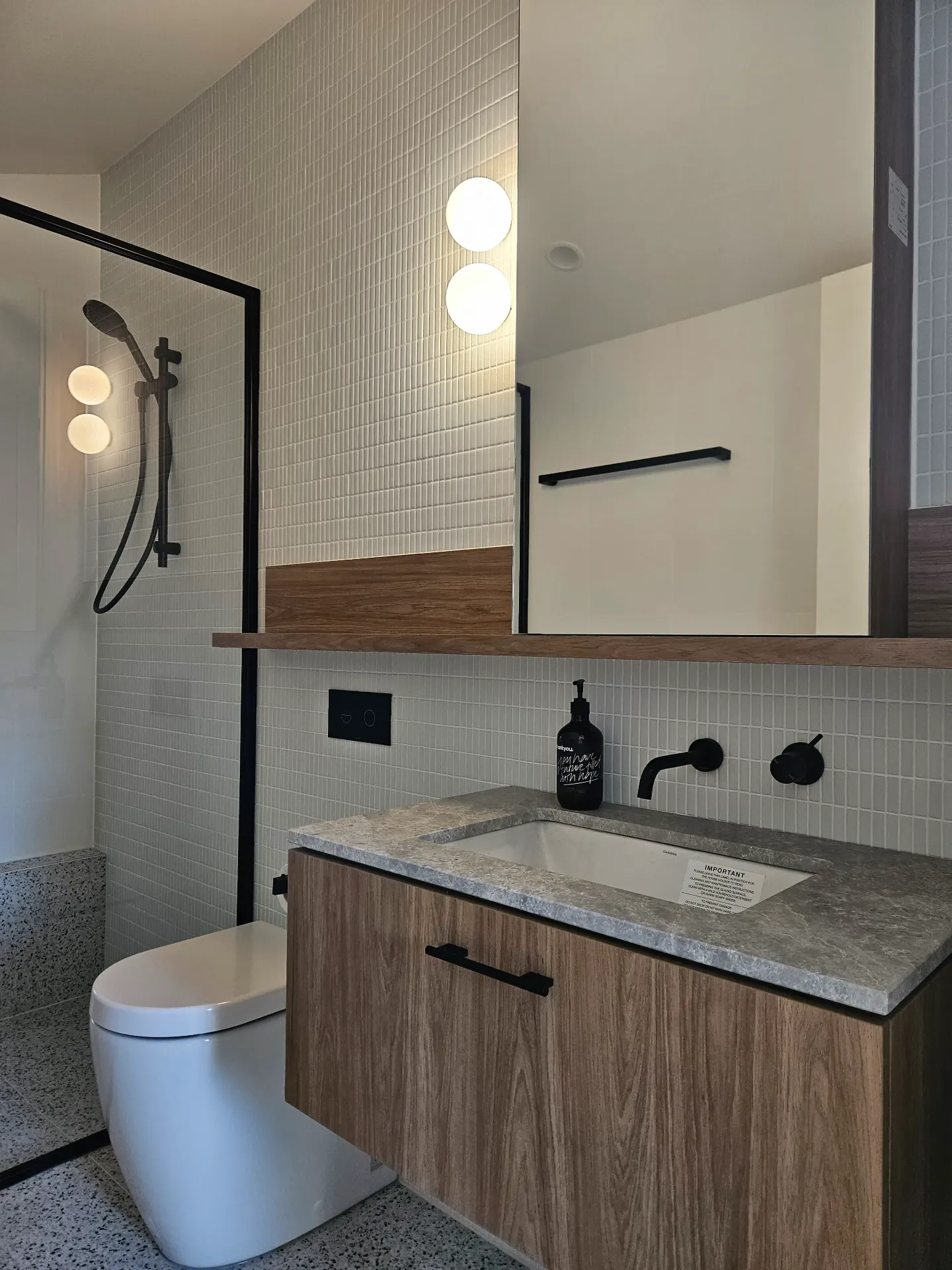 Yarraville cottage bathroom with black tapware and timber