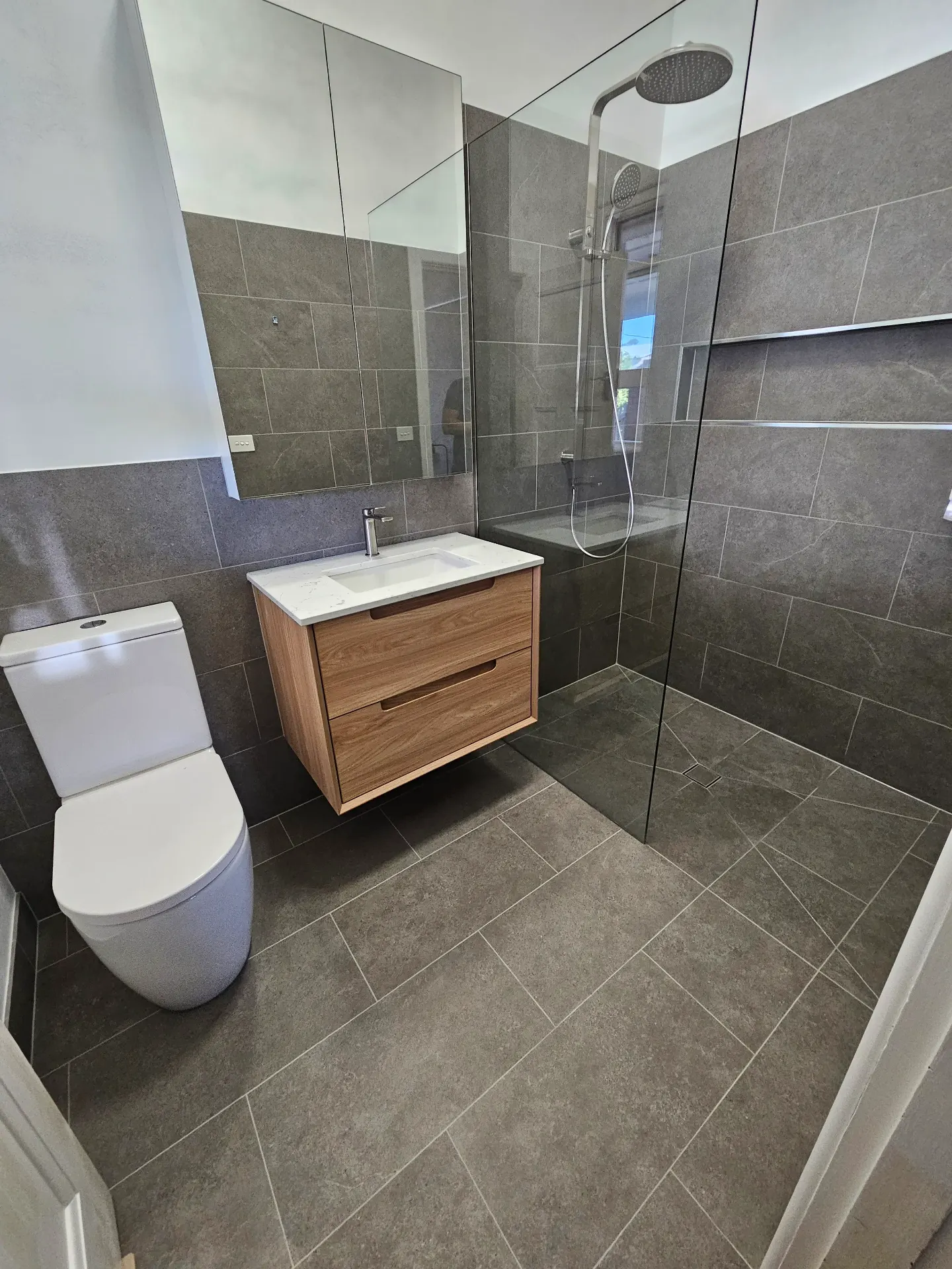 Brighton family bathroom with grey stone and timber