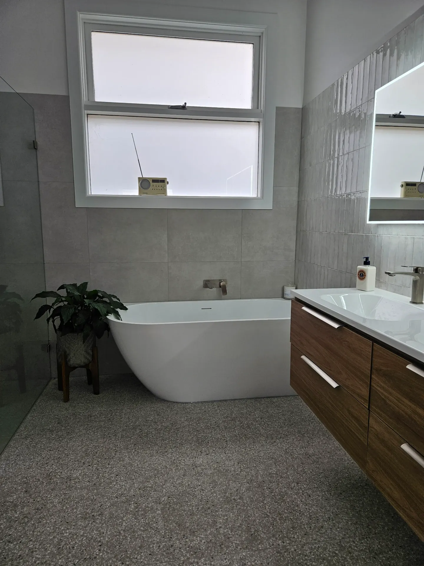Yarraville bathroom with grey tile and walnut vanity