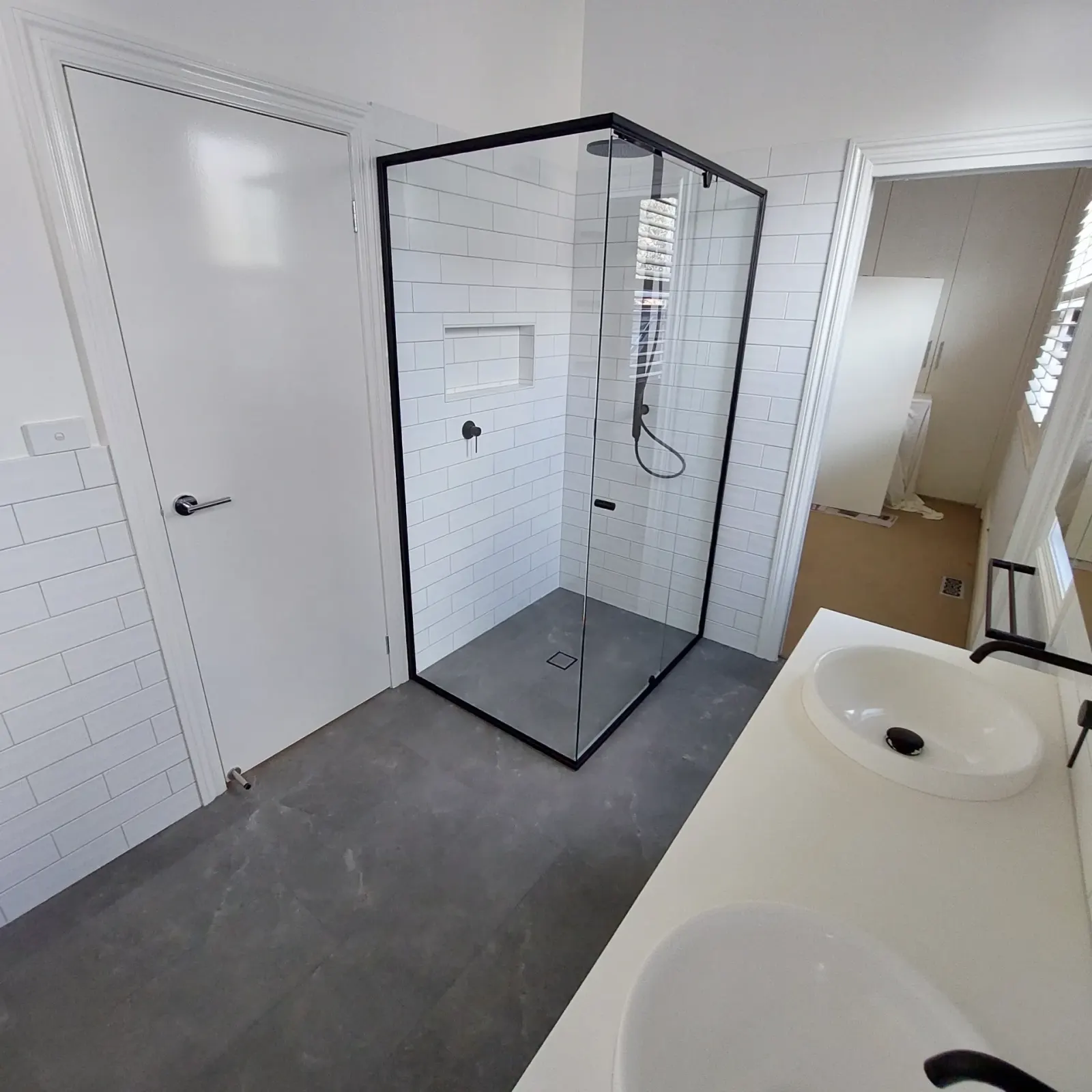 Small apartment bathroom with white subway tile wet-room