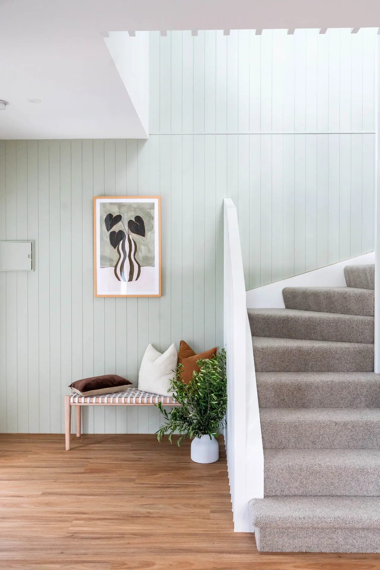 Sage green VJ panel entry with timber staircase
