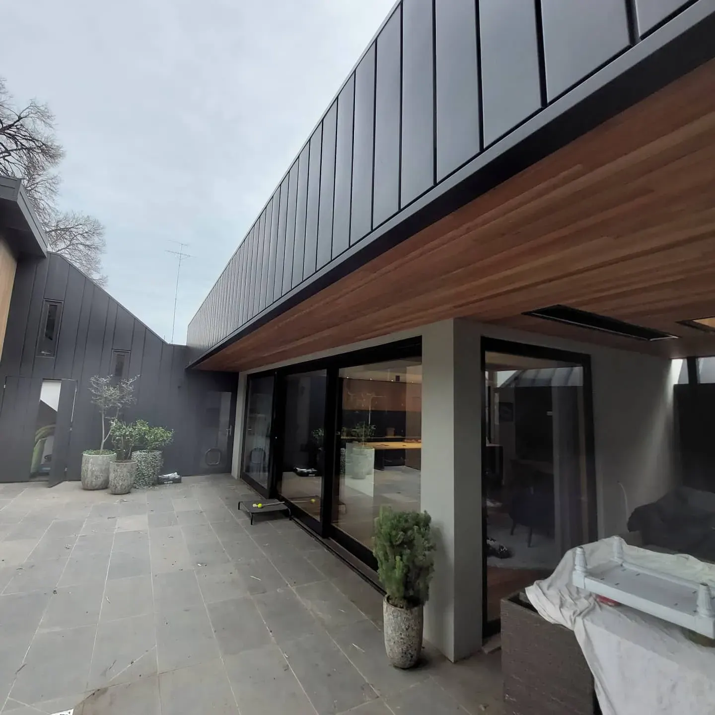 Rear extension with zinc cladding and timber soffit opening to courtyard