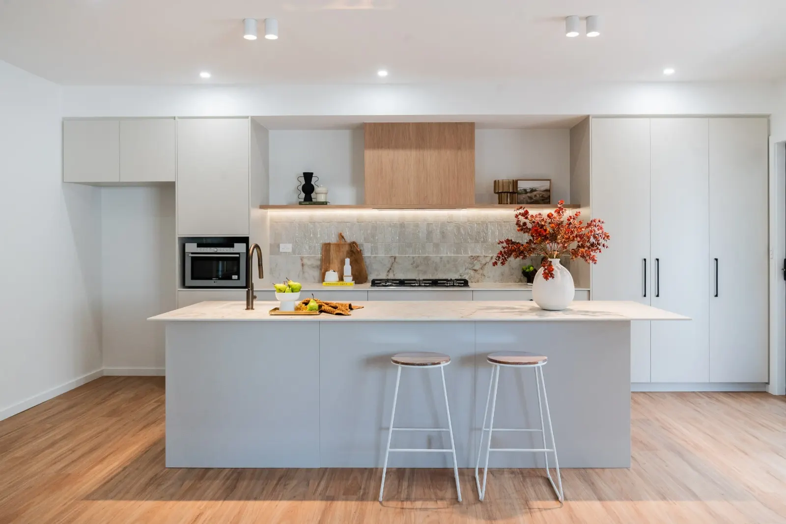 Editorial kitchen renovation with island and timber rangehood
