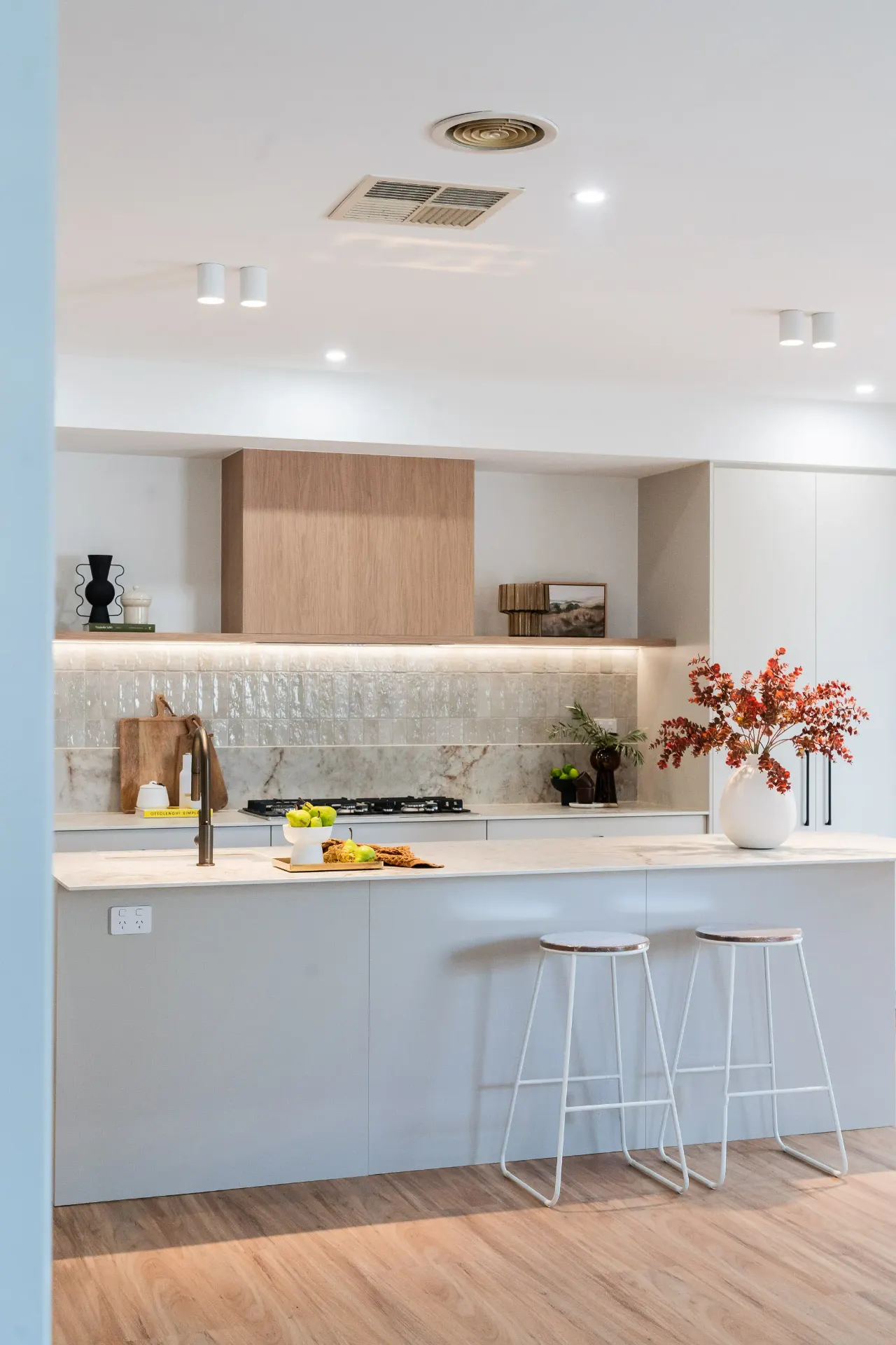 Wide editorial kitchen island with timber rangehood